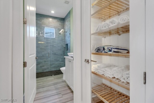 3721 Sapphire Cove Cir, Naples, FL 34114 - full bathroom with a stall shower, wood finished floors, vanity, and toilet