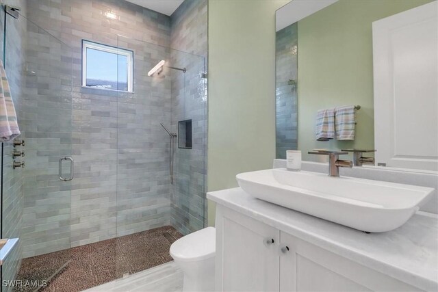 3721 Sapphire Cove Cir, Naples, FL 34114 - full bathroom featuring a stall shower, vanity, and toilet