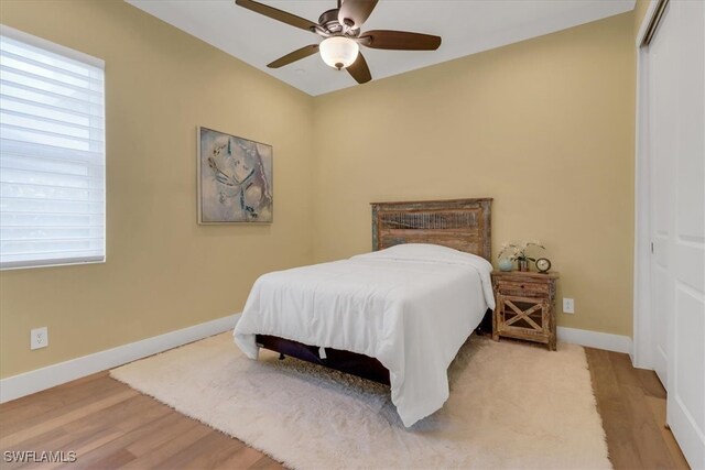 3721 Sapphire Cove Cir, Naples, FL 34114 - bedroom with a closet, baseboards, wood finished floors, and a ceiling fan