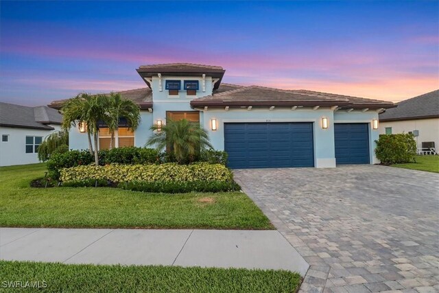 3721 Sapphire Cove Cir, Naples, FL 34114 - view of front of house with decorative driveway, a garage, a tile roof, and a front lawn
