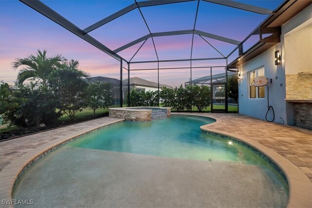 3721 Sapphire Cove Cir, Naples, FL 34114 - pool at dusk featuring a patio area, a pool with connected hot tub, and glass enclosure
