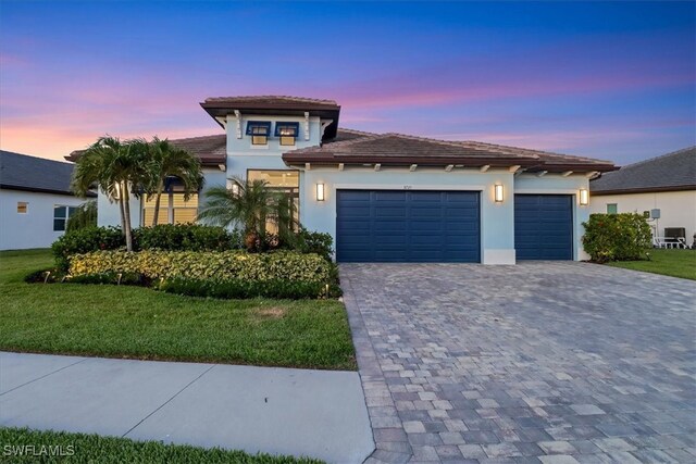 3721 Sapphire Cove Cir, Naples, FL 34114 - view of front of property with decorative driveway, stucco siding, an attached garage, a lawn, and a tiled roof