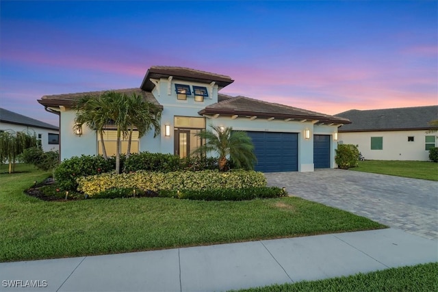 3721 Sapphire Cove Cir, Naples, FL 34114 - view of front of house featuring stucco siding, decorative driveway, an attached garage, a front yard, and a tiled roof