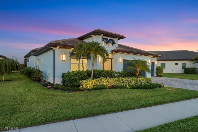 3721 Sapphire Cove Cir, Naples, FL 34114 - view of front of property with decorative driveway, a garage, a yard, and stucco siding