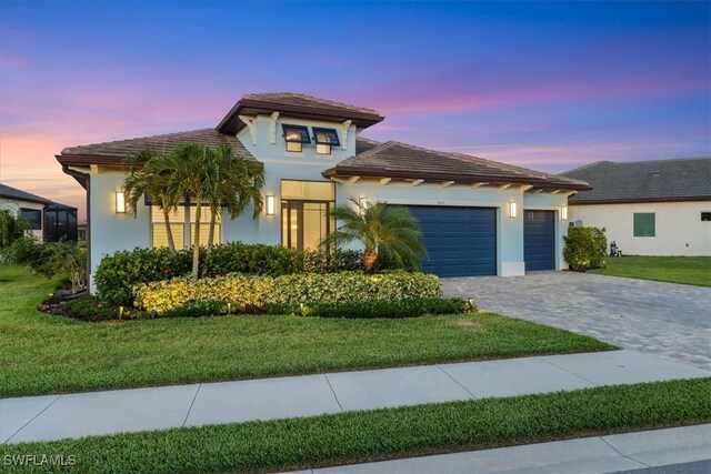 3721 Sapphire Cove Cir, Naples, FL 34114 - view of front of home featuring decorative driveway, a garage, stucco siding, a lawn, and a tile roof