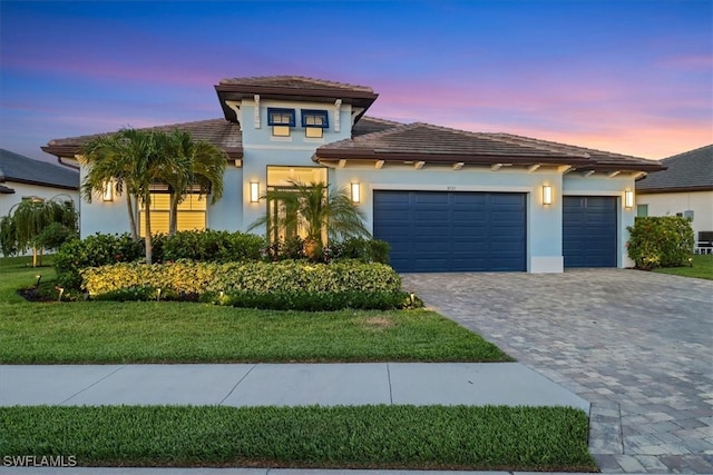 3721 Sapphire Cove Cir, Naples, FL 34114 - mediterranean / spanish-style house featuring decorative driveway, an attached garage, stucco siding, and a tiled roof