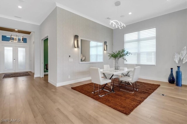 3721 Sapphire Cove Cir, Naples, FL 34114 - dining space featuring a chandelier, wood finished floors, baseboards, crown molding, and french doors