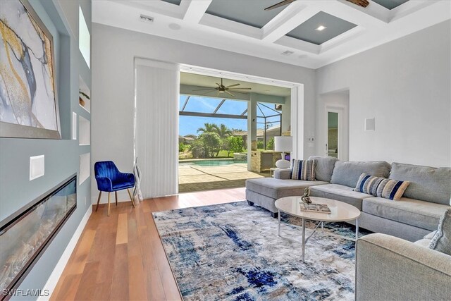 3721 Sapphire Cove Cir, Naples, FL 34114 - living area featuring a ceiling fan, coffered ceiling, wood finished floors, a sunroom, and beam ceiling