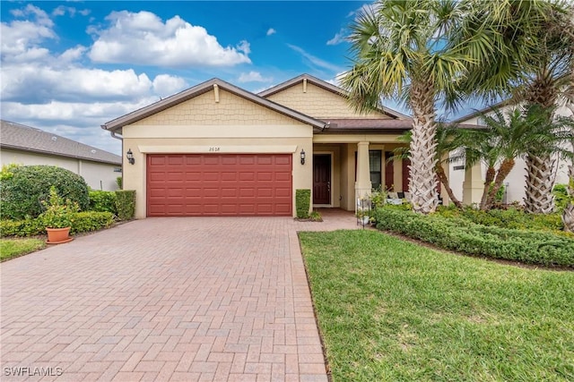 2628 Sherman Oak Dr, North Port, FL 34289 - view of front of home featuring stucco siding, a front lawn, decorative driveway, and a garage