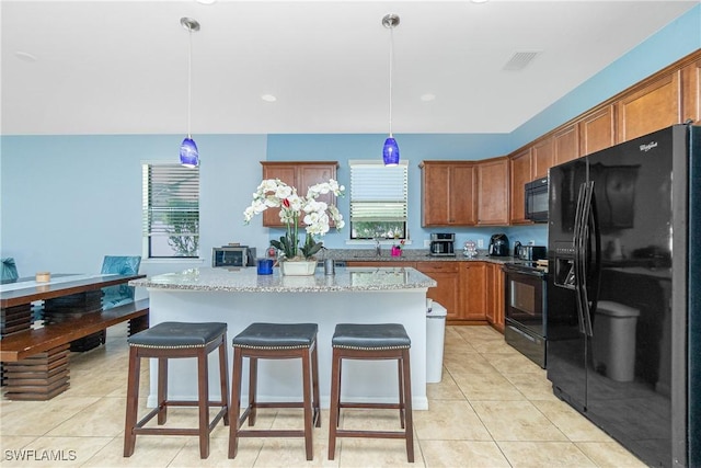 2628 Sherman Oak Dr, North Port, FL 34289 - kitchen featuring black appliances, light tile patterned floors, and brown cabinetry
