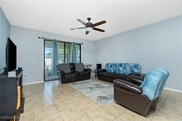 2628 Sherman Oak Dr, North Port, FL 34289 - living area featuring light tile patterned floors, a ceiling fan, and baseboards