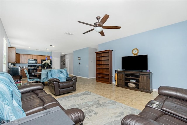 2628 Sherman Oak Dr, North Port, FL 34289 - living room featuring light tile patterned flooring, baseboards, and a ceiling fan