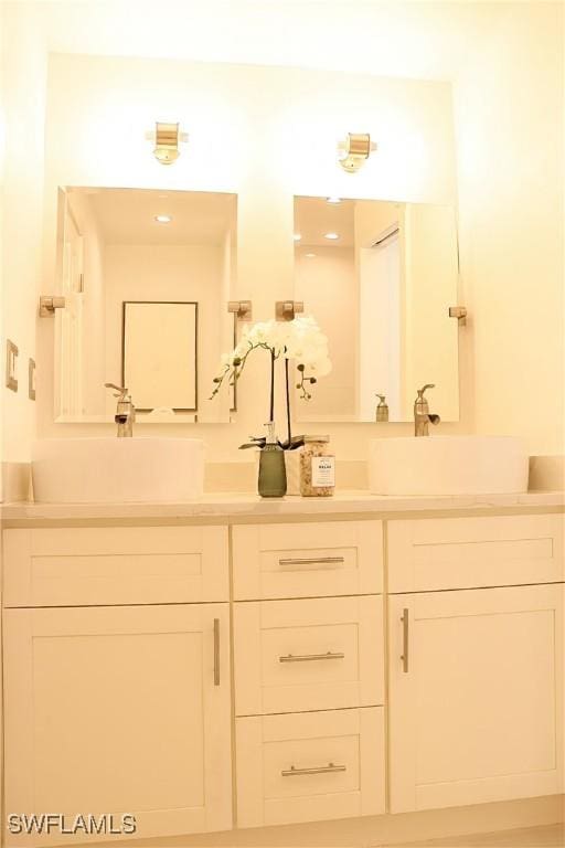 full bathroom featuring double vanity and a sink