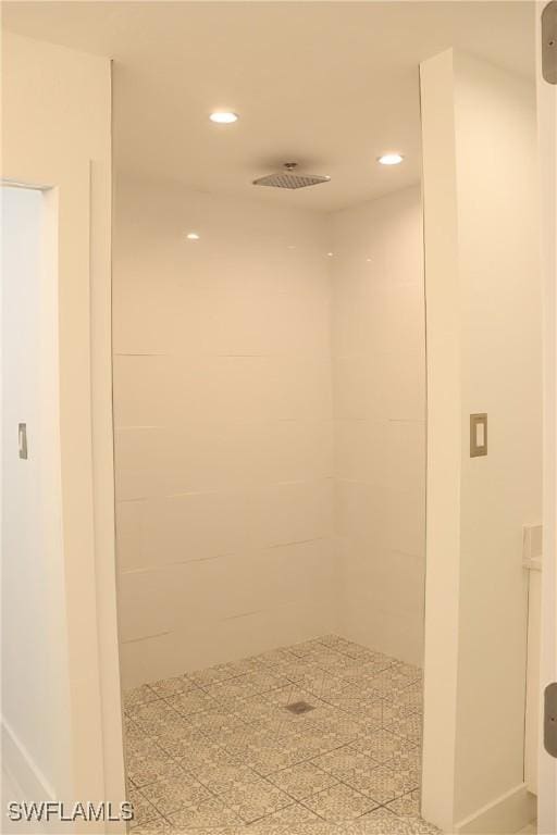 bathroom with a tile shower and recessed lighting