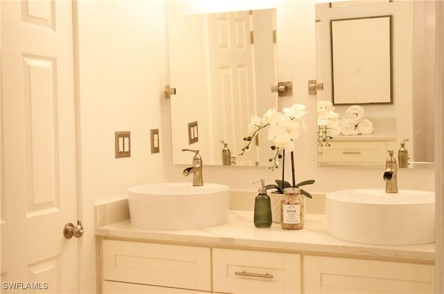 full bathroom featuring double vanity and a sink