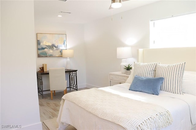 bedroom with baseboards and wood finished floors
