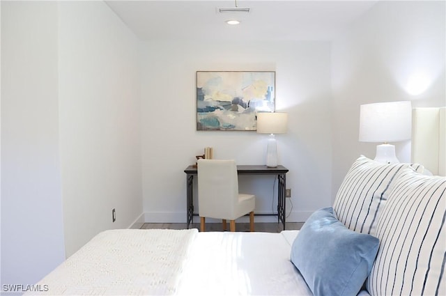 bedroom with baseboards, wood finished floors, and recessed lighting