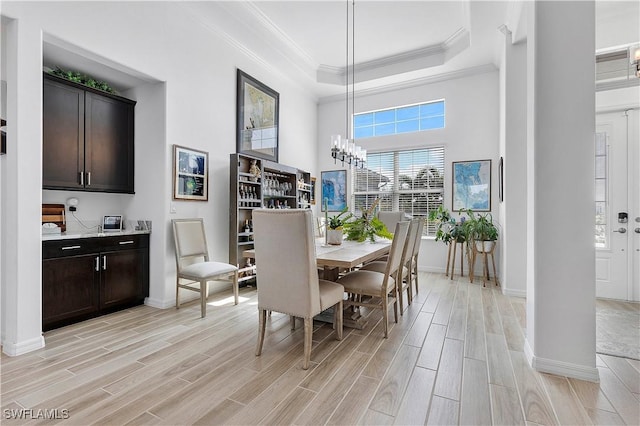 dining area with crown molding, baseboards, and wood finish floors