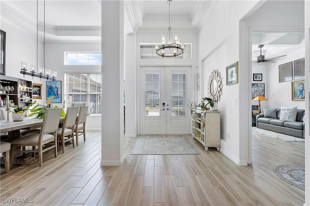 foyer featuring crown molding and wood finish floors
