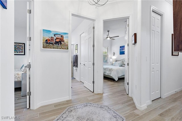 hall featuring wood finish floors and baseboards