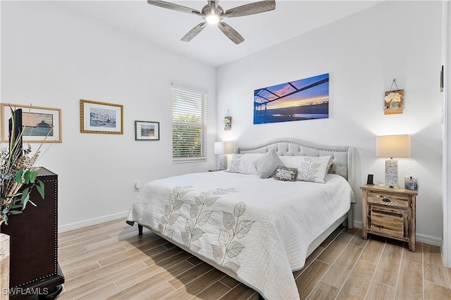 bedroom with ceiling fan, baseboards, and wood finish floors
