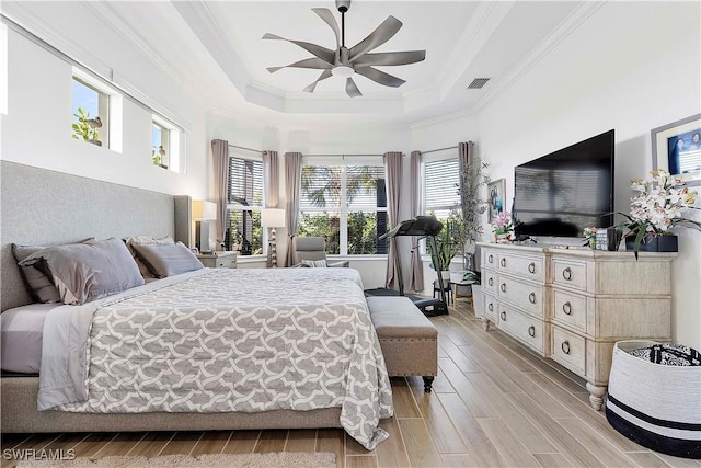 bedroom featuring a raised ceiling, ornamental molding, visible vents, and wood tiled floor