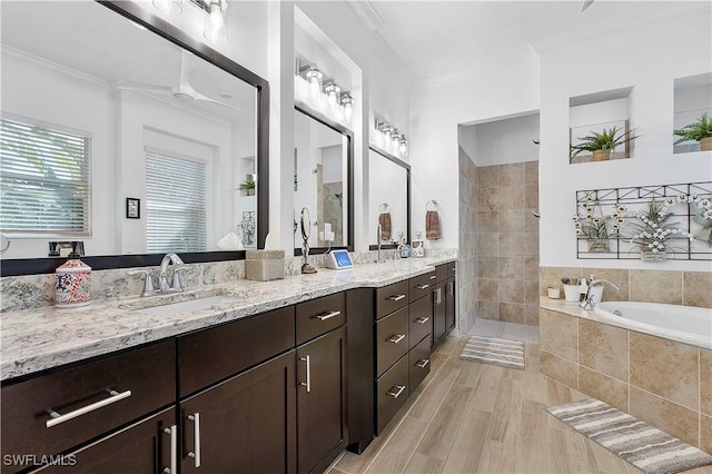 bathroom featuring crown molding, a bath, a walk in shower, and a sink