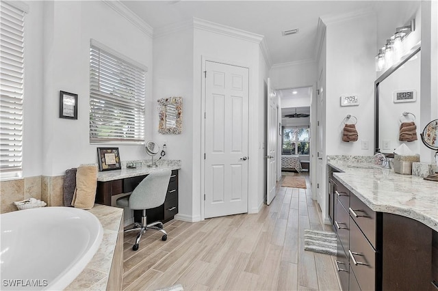 bathroom featuring crown molding, ensuite bathroom, and wood finished floors
