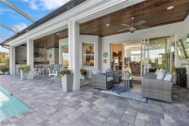 view of patio / terrace featuring a lanai, outdoor lounge area, and ceiling fan