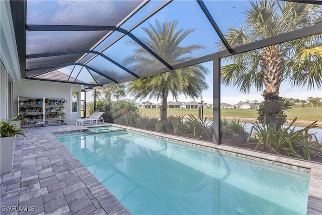 view of pool featuring a patio, a pool with connected hot tub, and a lanai