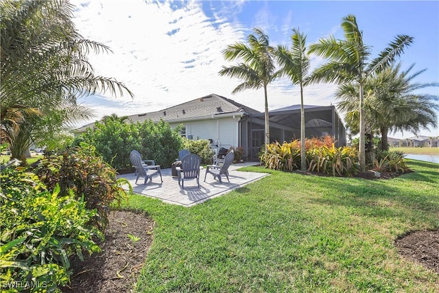 view of yard featuring a water view, a lanai, and a patio area