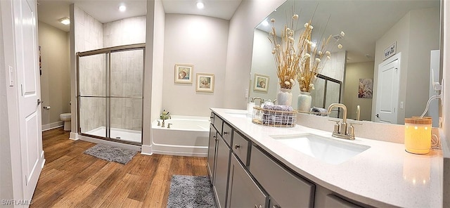 411 SW 19th Ter, Cape Coral, FL 33991 - full bathroom with a shower stall, toilet, wood finished floors, a bath, and a sink