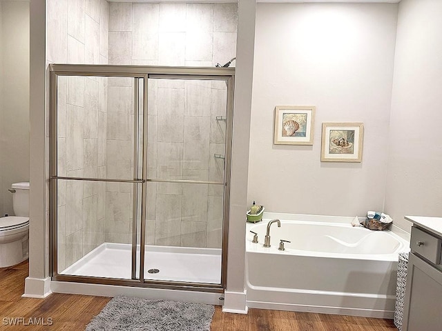 411 SW 19th Ter, Cape Coral, FL 33991 - full bathroom with wood finished floors, toilet, a bath, and a stall shower