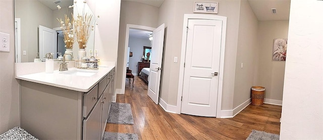 411 SW 19th Ter, Cape Coral, FL 33991 - bathroom featuring ceiling fan, baseboards, wood finished floors, and vanity