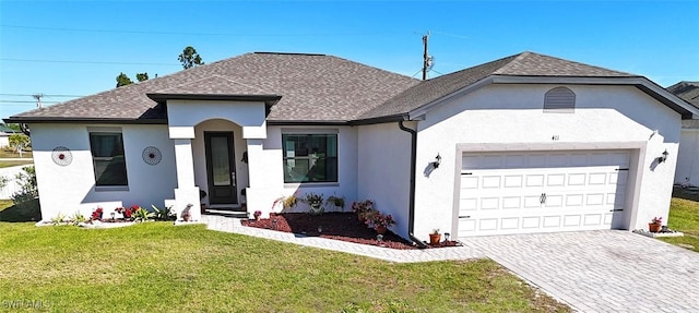 411 SW 19th Ter, Cape Coral, FL 33991 - view of front facade featuring stucco siding, driveway, a shingled roof, and a front lawn