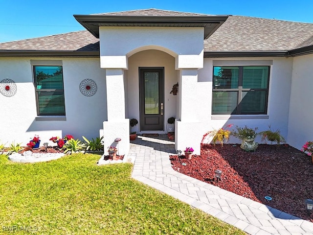 411 SW 19th Ter, Cape Coral, FL 33991 - entrance to property with stucco siding, a lawn, and roof with shingles