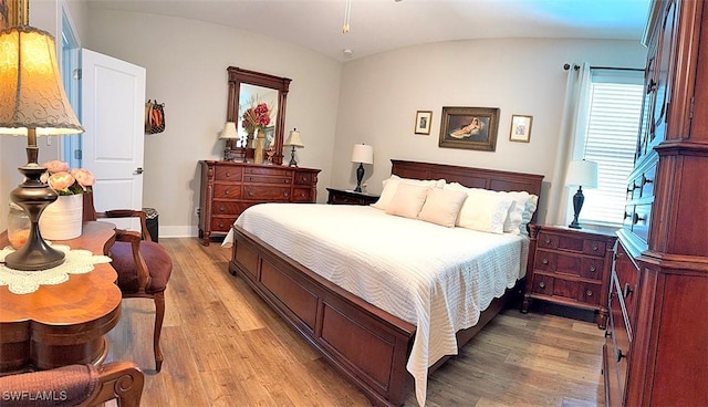 411 SW 19th Ter, Cape Coral, FL 33991 - bedroom featuring baseboards, light wood-style flooring, and vaulted ceiling