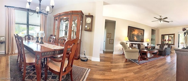 411 SW 19th Ter, Cape Coral, FL 33991 - dining area with ceiling fan with notable chandelier, lofted ceiling, baseboards, and wood finished floors
