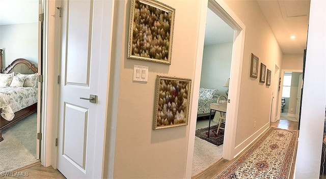 411 SW 19th Ter, Cape Coral, FL 33991 - corridor featuring carpet floors, baseboards, and wood finished floors