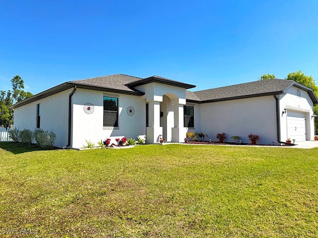 411 SW 19th Ter, Cape Coral, FL 33991 - view of front of house featuring a garage, a front yard, and stucco siding