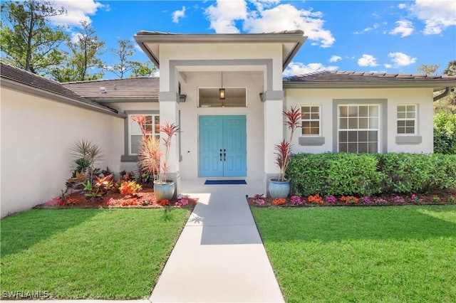 1420 14th Ave NE, Naples, FL 34120 - entrance to property with a lawn, stucco siding, and a tile roof