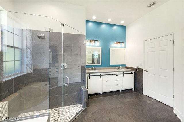 1420 14th Ave NE, Naples, FL 34120 - bathroom featuring double vanity, a stall shower, recessed lighting, tile walls, and wainscoting