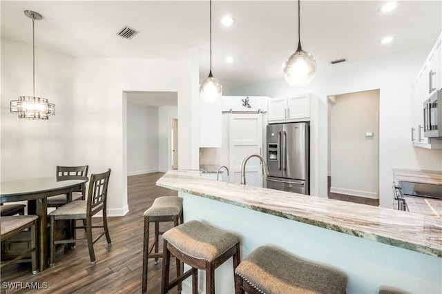 1420 14th Ave NE, Naples, FL 34120 - kitchen featuring stainless steel appliances, dark wood finished floors, white cabinetry, light stone counters, and baseboards