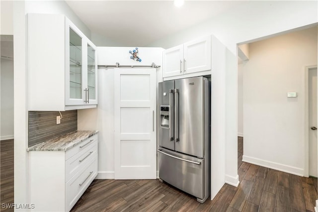 1420 14th Ave NE, Naples, FL 34120 - kitchen featuring high end fridge, decorative backsplash, white cabinets, dark wood finished floors, and light stone counters