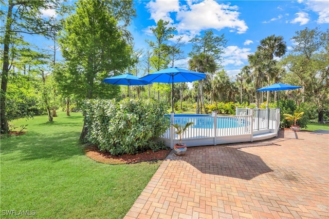 1420 14th Ave NE, Naples, FL 34120 - outdoor pool featuring a lawn, a patio, and view of scattered trees