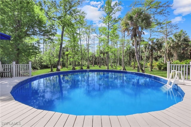 1420 14th Ave NE, Naples, FL 34120 - outdoor pool with a deck, view of scattered trees, and a yard