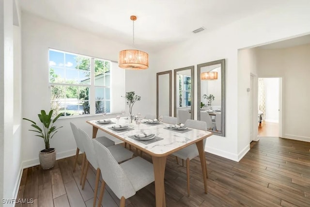 1420 14th Ave NE, Naples, FL 34120 - dining area with dark wood finished floors, baseboards, and a chandelier