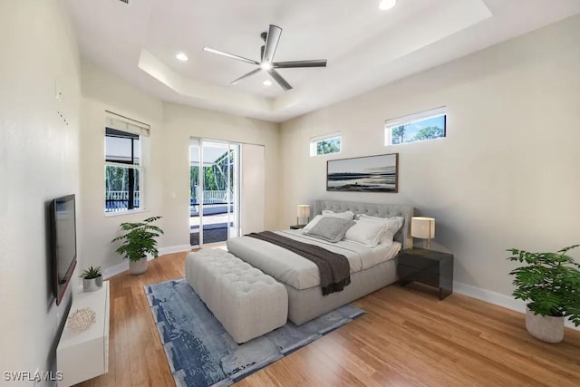 1420 14th Ave NE, Naples, FL 34120 - bedroom featuring a tray ceiling, access to outside, light wood-style floors, baseboards, and recessed lighting
