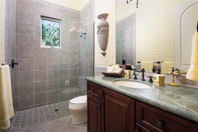 23771 Tuscany Way, Bonita Springs, FL 34134 - bathroom featuring toilet, a walk in shower, vanity, tile patterned flooring, and wallpapered walls