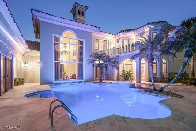 23771 Tuscany Way, Bonita Springs, FL 34134 - view of pool featuring a pool with connected hot tub, a patio area, and french doors